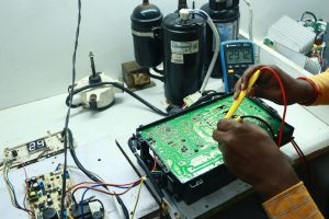 Advanced inverter AC PCB board repair and voltage testing.